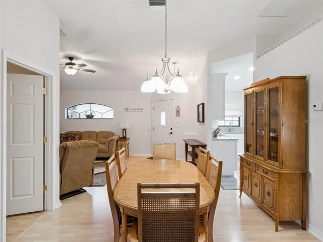 THE DINING ROOM LOOKING TOWARD THE ENTRY AND LIVING ROOM