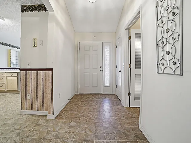 Welcoming foyer with coat closet.