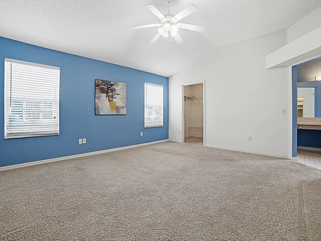 The primary suite offers vaulted ceilings