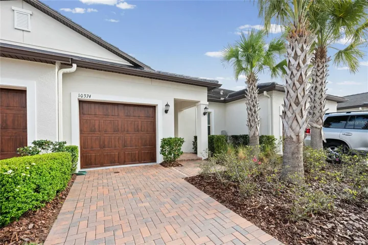 One car garage and long paver driveway