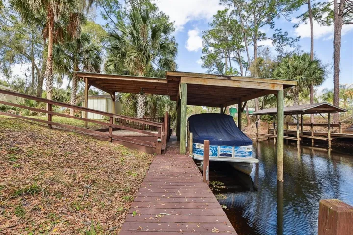Covered boat dock on canal with freshwater sink