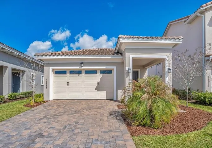 BUILT IN 2023 and showing LIKE NEW, this modern single-story home in the 24-hour guard-gated golf community of Eagle Creek delivers style, functionality, and low-maintenance living in the heart of Lake Nona!