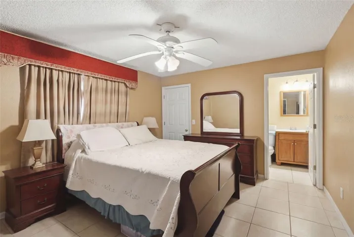 virtually staged Primary bedroom suite. Bathroom at right.