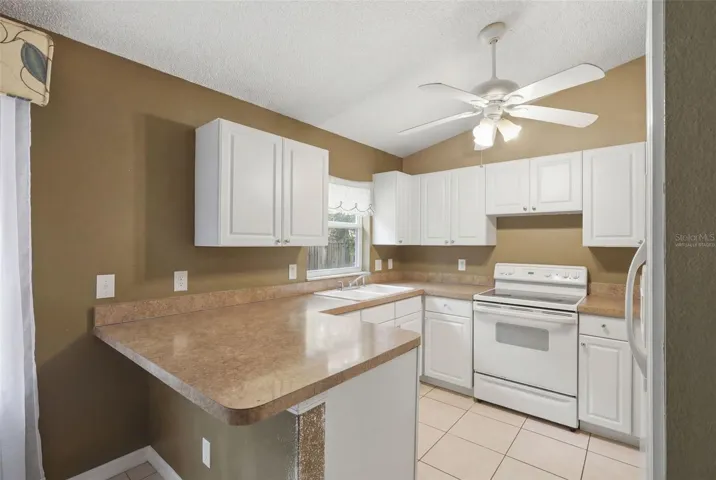 Virtually staged. Kitchen with breakfast bar