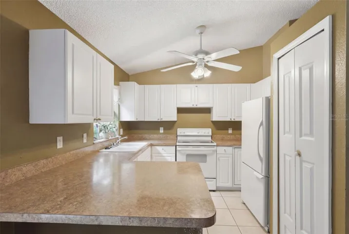 Virtually staged Kitchen. Pantry at right