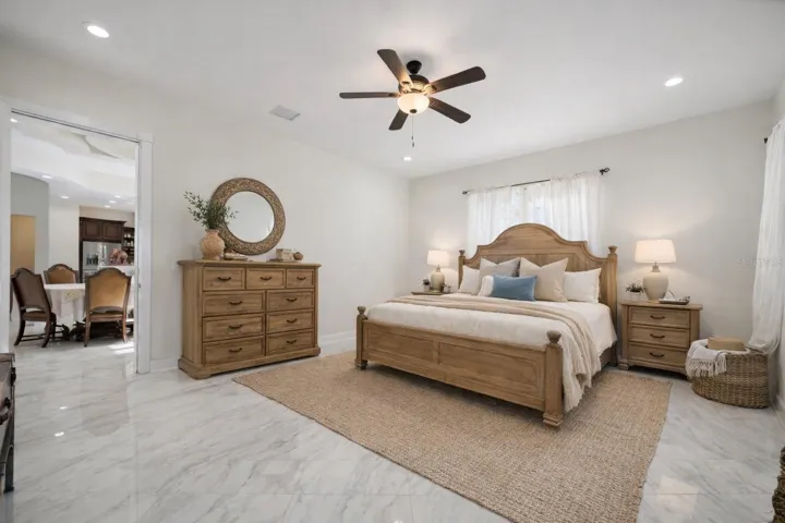 Primary bedroom, bottom floor, with ensuite and walk in closet - Virtual staging added to demonstrate possible furniture placement.