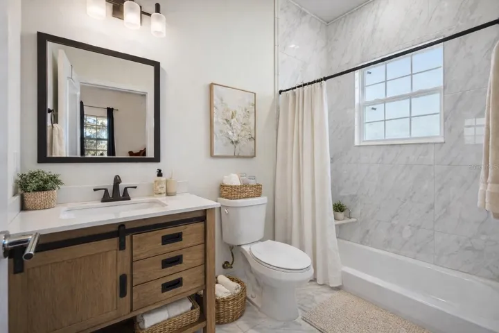 2nd downstairs en suite - Virtual staging added to demonstrate possible furniture placement.