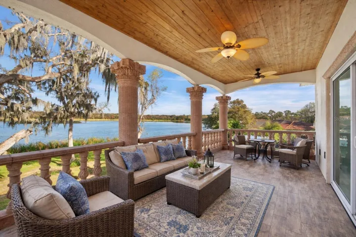 Upstairs rear balcony - Virtual staging added to demonstrate possible furniture placement.