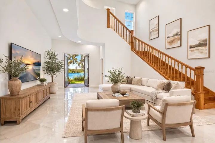 Living room, with view of lake - Virtual staging added to demonstrate possible furniture placement.