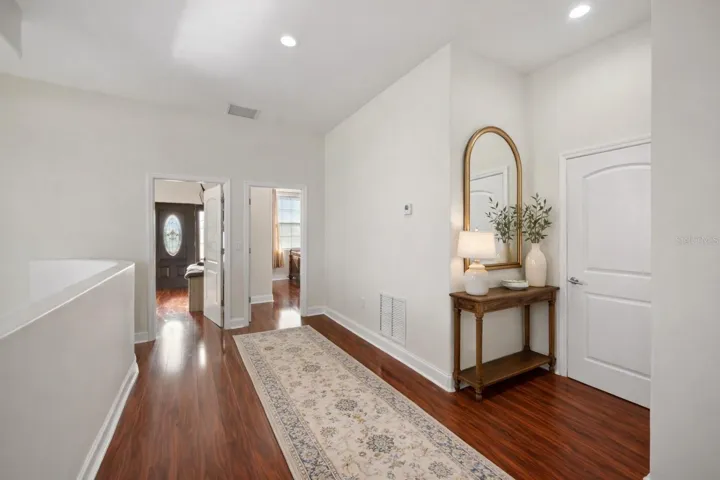 Upstairs hall area, door to the right is access to upstairs laundry - Virtual staging added to demonstrate possible furniture placement.