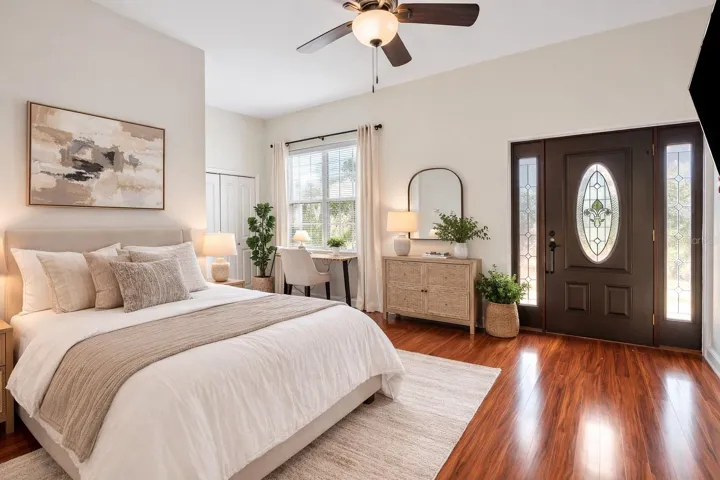 Upstairs front bedroom, en-suite, and balcony - Virtual staging added to demonstrate possible furniture placement.