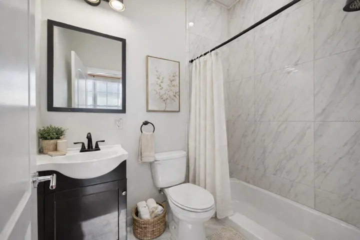 Front left bedroom en-suite - Virtual staging added to demonstrate possible furniture placement.