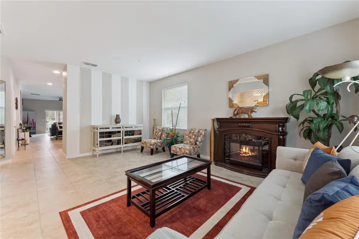 Formal Living & Dining Combo looking into the Kitchen/Family Room. Kitchen is located behind the stiped wall.