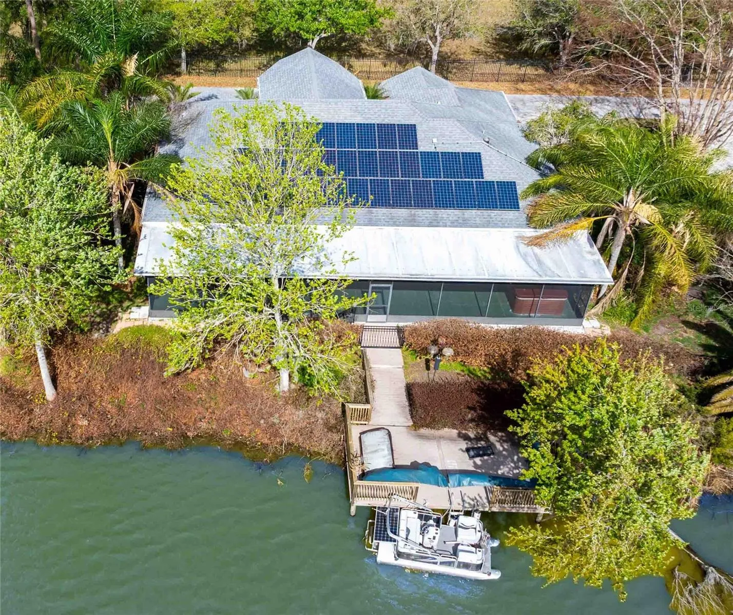 Aerial view of the solar panels, low monthly electric bills, large screen lanai with hot tub and dock
