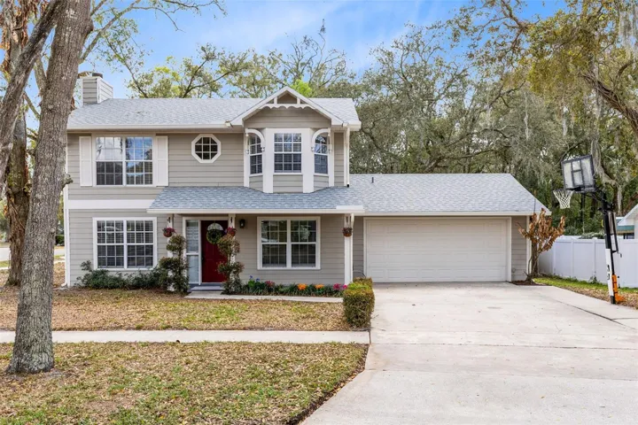 Welcoming Front Exterior with extra long and wide driveway and mature landscaping