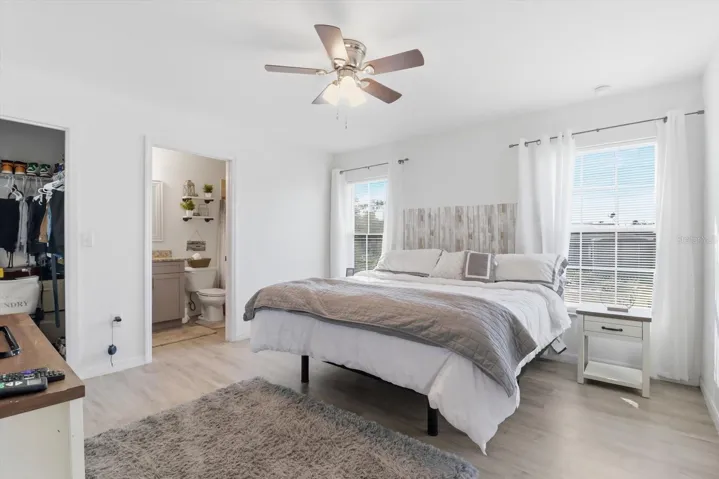 Master bedroom with walk in closet and bathroom with shower.