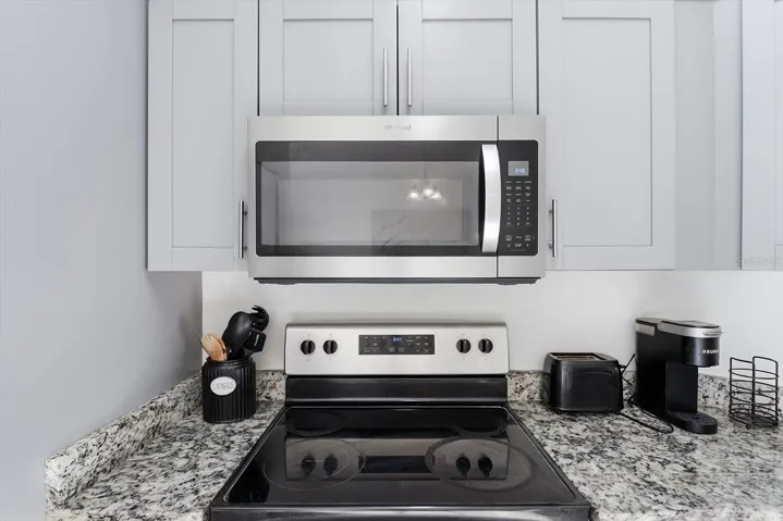 Stainless steel Microwave and stove with oven.