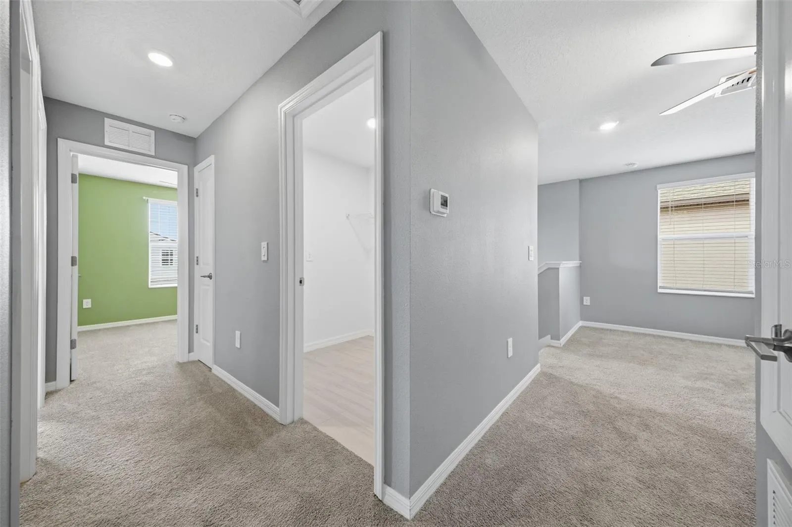 View of the loft, laundry room and hallway to secondary bedrooms