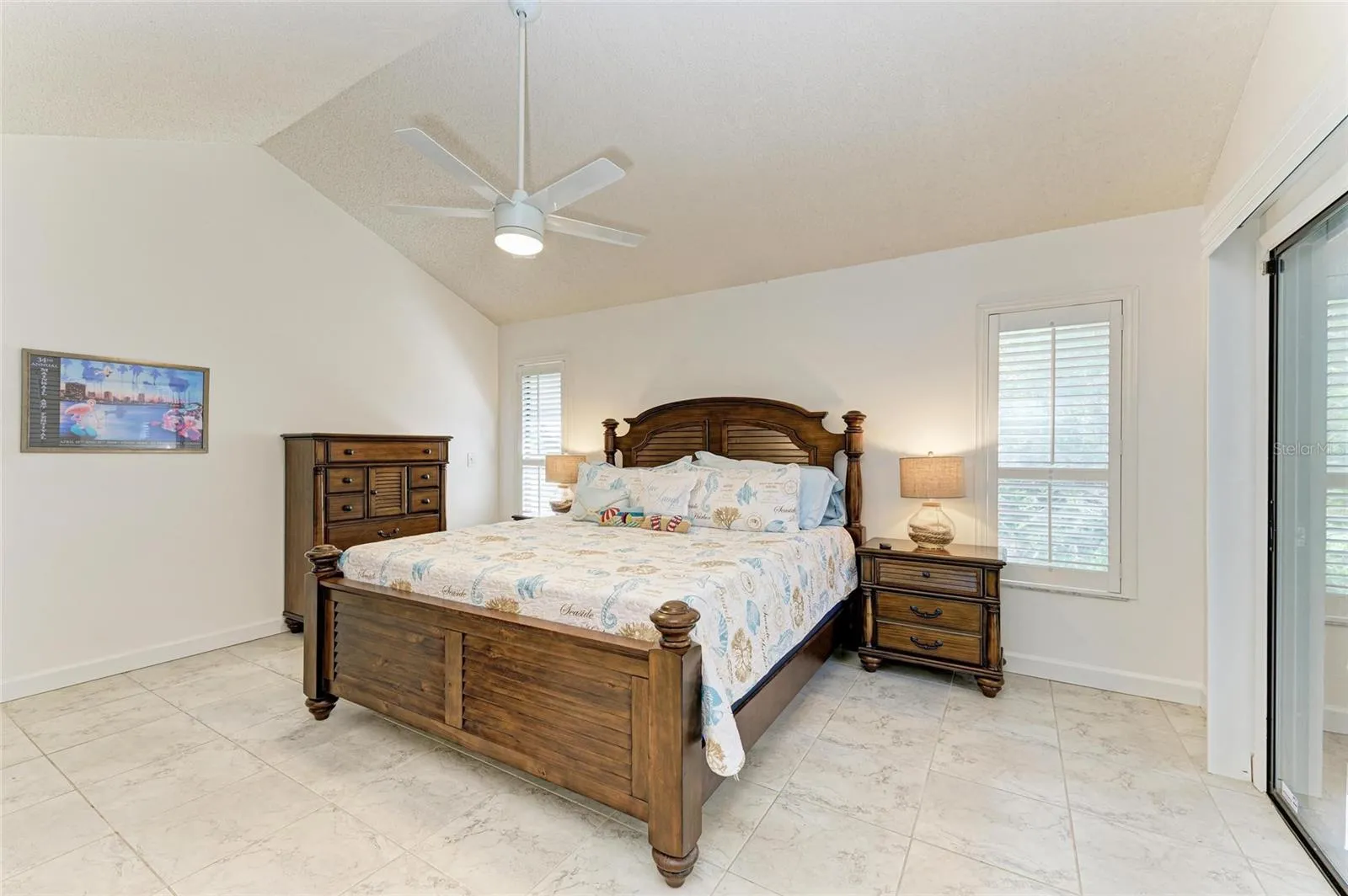 Primary Bedroom with ensuite bath and access to screened in lanai.