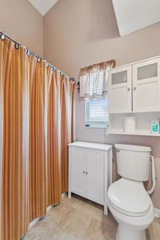 Water closet with walk-in shower and comfort height toilet