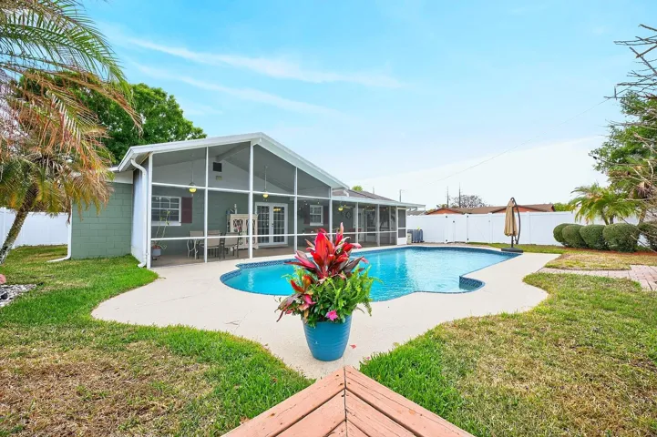 Enjoy relaxing in your own private sparkling in-ground pool with walk-in steps, all surrounded by a fenced yard for added privacy.