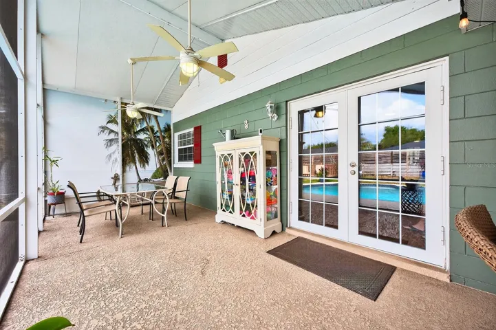 Step outside to your private backyard oasis, where a covered and screened patio with dual ceiling fans overlooks the sparkling in-ground pool.