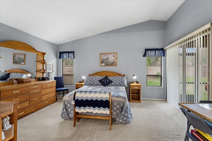 Primary bedroom with sliding glass doors to back porch