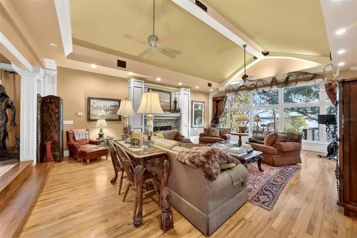 The Great Room with grand stone Fireplace, this Great room has a stunning wall to wall view of Lake Dora!