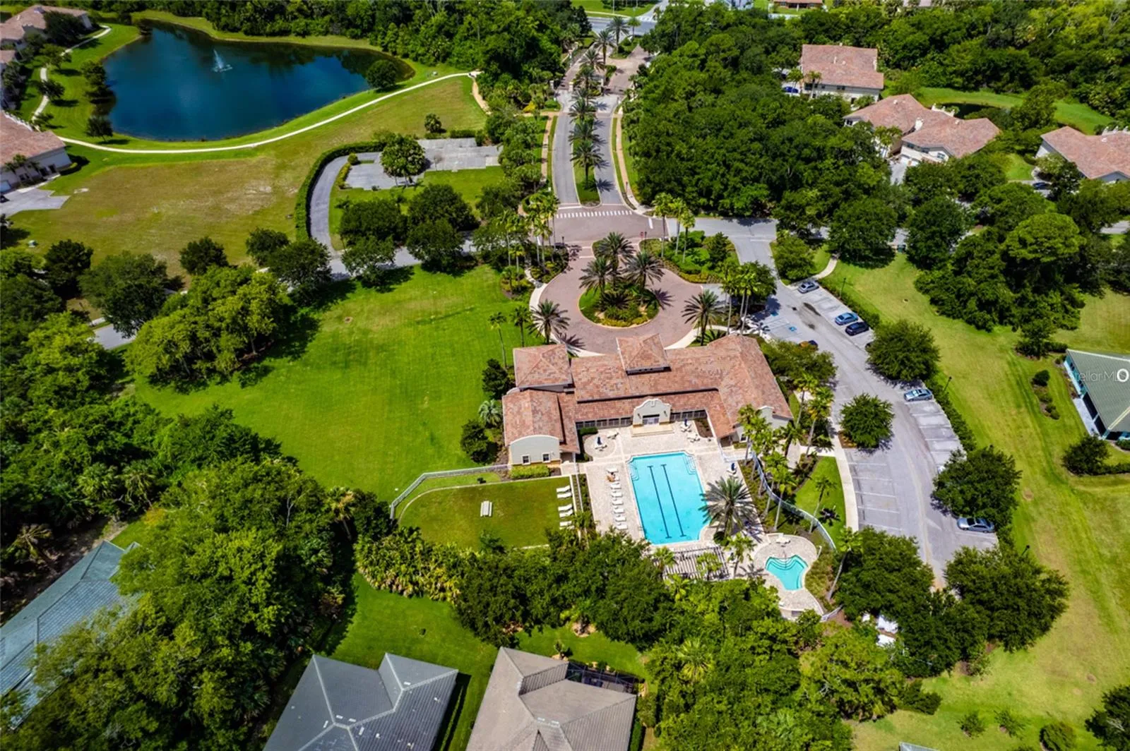 Clubhouse: Drone Shot Of The Clubhouse Complex With Large Heated Pool And Relaxing Spa