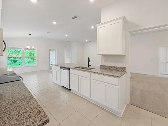 White Cabinets and Granites counter Tops with Black fixtures