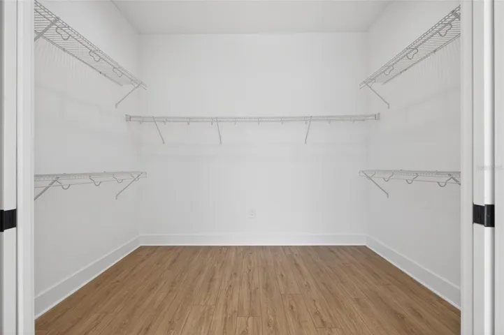Dual sliding pocket doors leading to large walk-in closet
