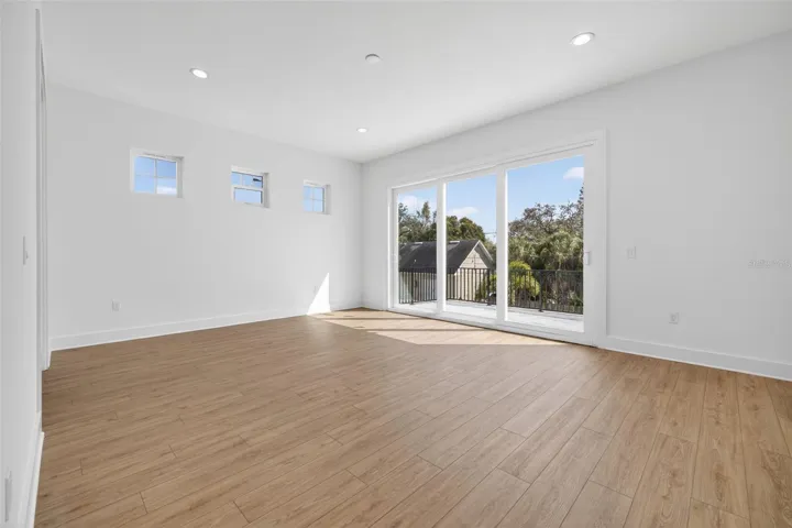 Primary suite with cascading sliders leading to patio deck