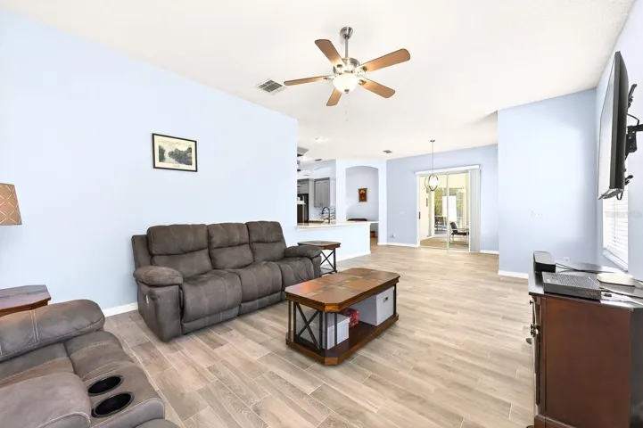 The Kitchen flows effortlessly into the Family Room, where large windows frame views of the BACKYARD OASIS.