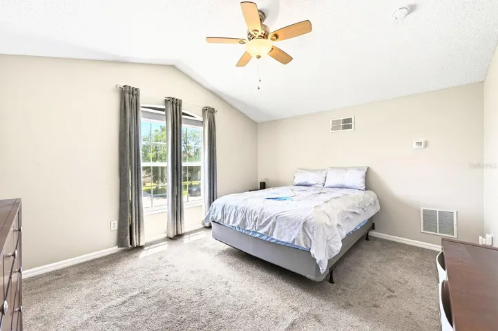 Upstairs, a PRIVATE FIFTH BEDROOM with vaulted ceilings and its own FULL BATH provides an ideal space for guests, a home office, or a bonus retreat.