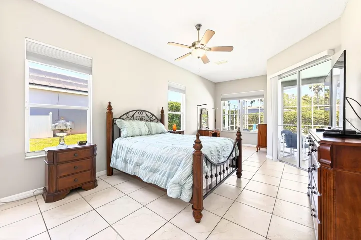 The Primary Suite is a true haven, accessed through elegant FRENCH DOORS and featuring abundant natural light, a SITTING AREA, dual closets (including a walk-in), and your own PRIVATE ENTRANCE to the patio and pool.