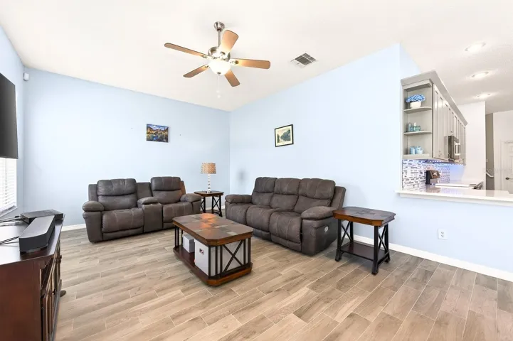 The Kitchen flows effortlessly into the Family Room, where large windows frame views of the BACKYARD OASIS.
