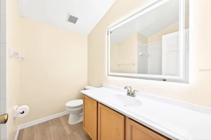 Upstairs, a PRIVATE FIFTH BEDROOM with vaulted ceilings and its own FULL BATH provides an ideal space for guests, a home office, or a bonus retreat.