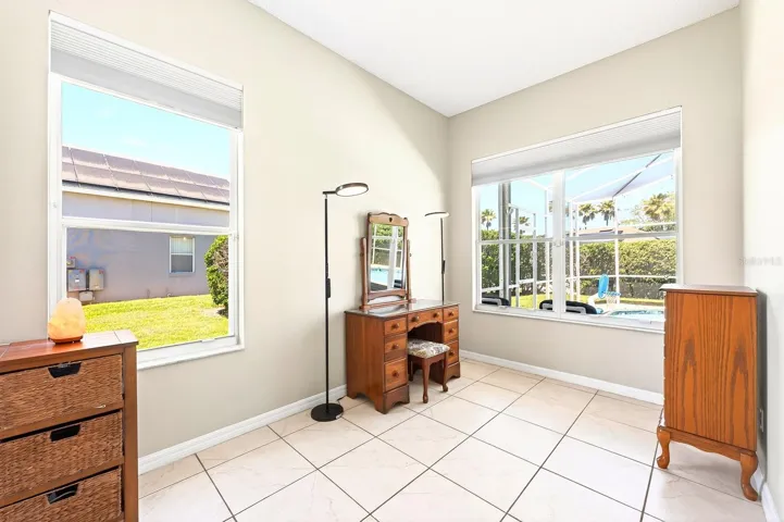The Primary Suite is a true haven, accessed through elegant FRENCH DOORS and featuring abundant natural light, a SITTING AREA, dual closets (including a walk-in), and your own PRIVATE ENTRANCE to the patio and pool.