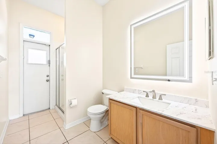 A CONVENIENT POOL BATH with direct exterior access adds both comfort and functionality.