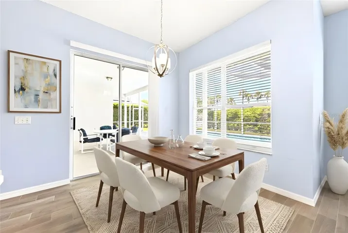 The Breakfast nook is filled with NATURAL LIGHT and features sliding doors that open directly to the patio and pool area, creating seamless indoor-outdoor living. Virtually Staged