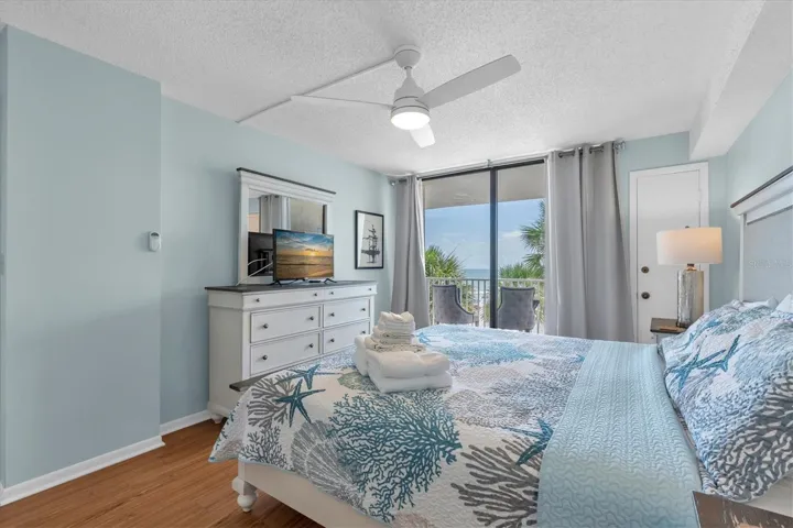 Primary bedroom with sliders leading to balcony