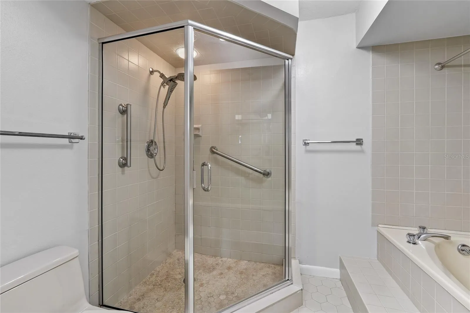 Primary En Suite Bathroom with tiled shower and jetted tubs