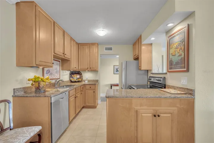 Wonderful Kitchen Appointed With Wood Cabinets, SS Appliances and Granite