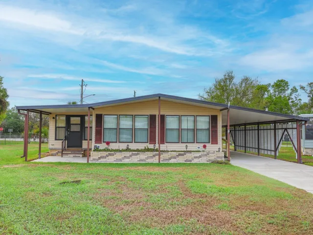 Front of the home. Featuring a 2 car covered carport and extended driveway.