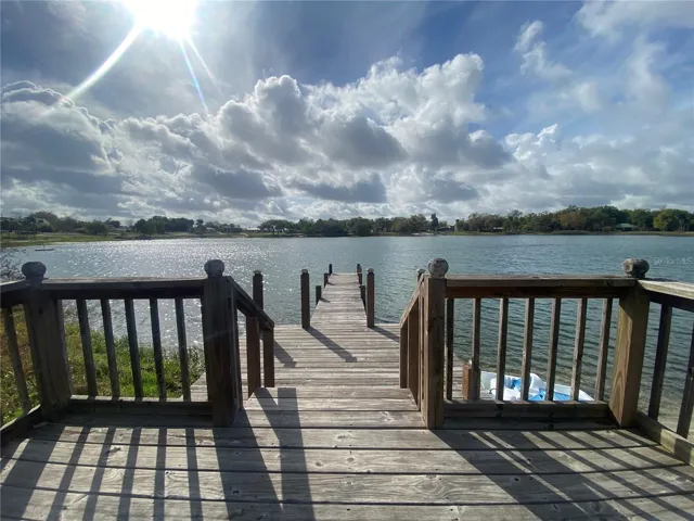 Lakefront view of the deck and dock area.  Saint Anne Lake is a private lake that only the property owners have access to.