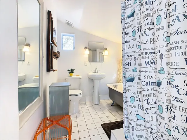 Bathroom has a claw foot tub and shower