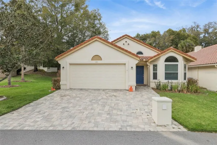 Attractive paver driveway adding charm and curb appeal to this beautifully updated home in Country Village of Tuscawilla... with BRAND NEW ROOF!