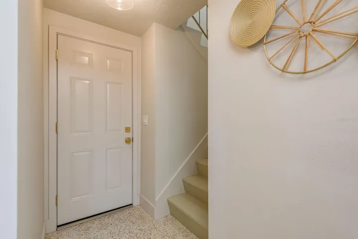 hallway, garage entry door and stairs to guest / in-law apartment