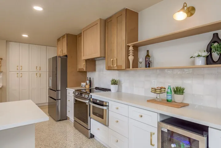 Chef's kitchen, ample counter space, wine cooler, modern quartz counters