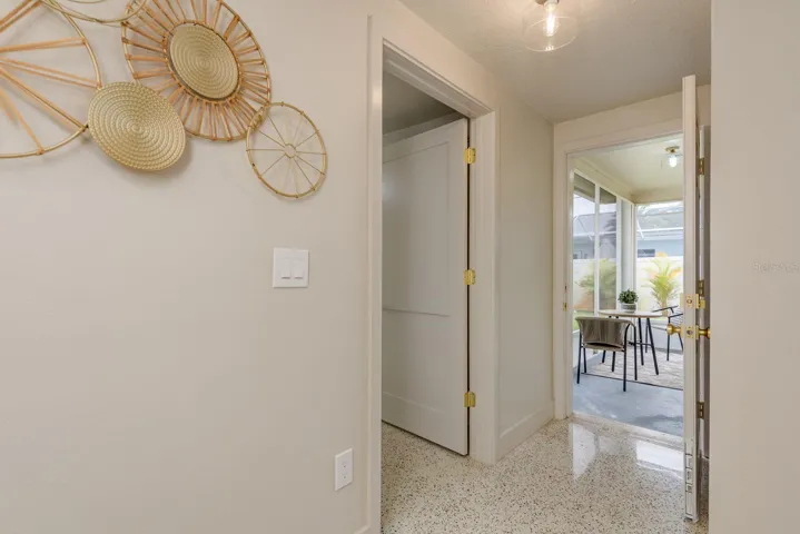 hallway to guest bedroom 2 and rear enclosed porch